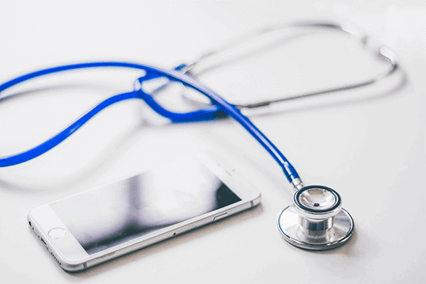 blue stethoscope next to a white iPhone