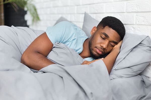 man sleeping in his bed