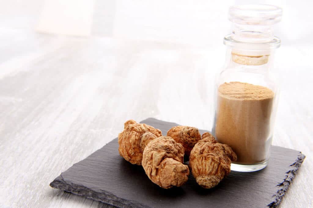 maca plant and plant extract in a glass bottle
