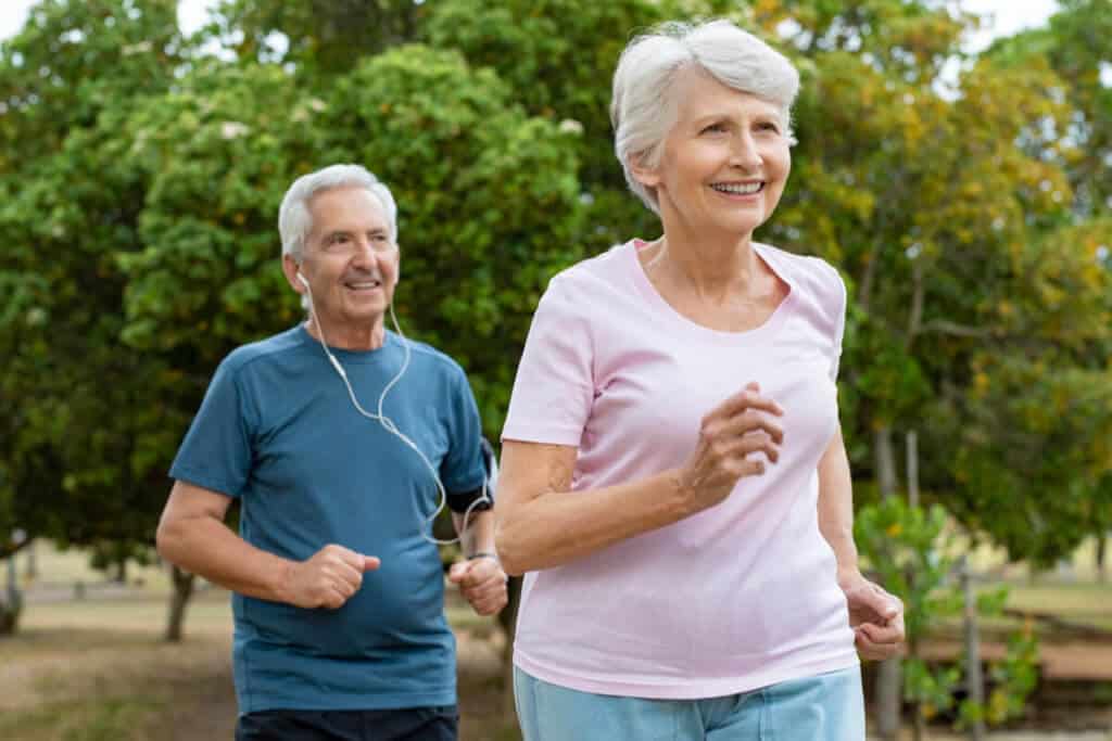two elderly running outside