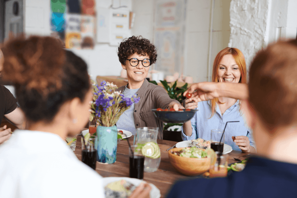 Image of woman passing bowl of food