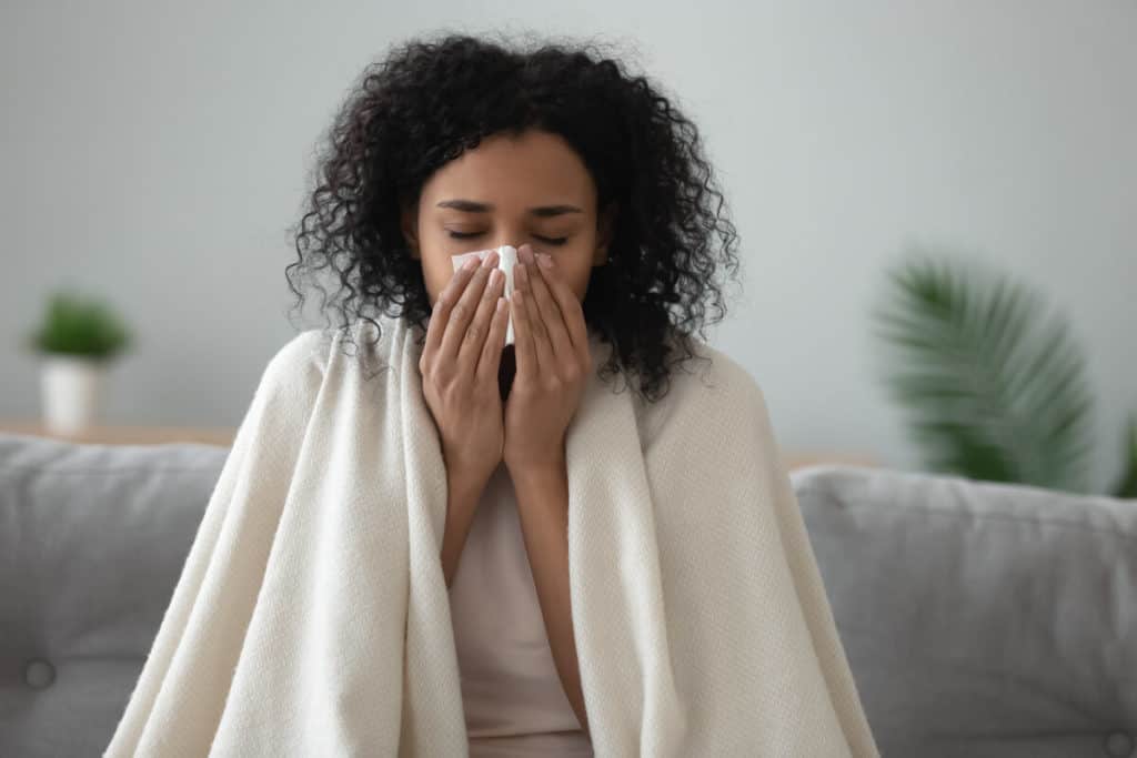 Woman sneezing