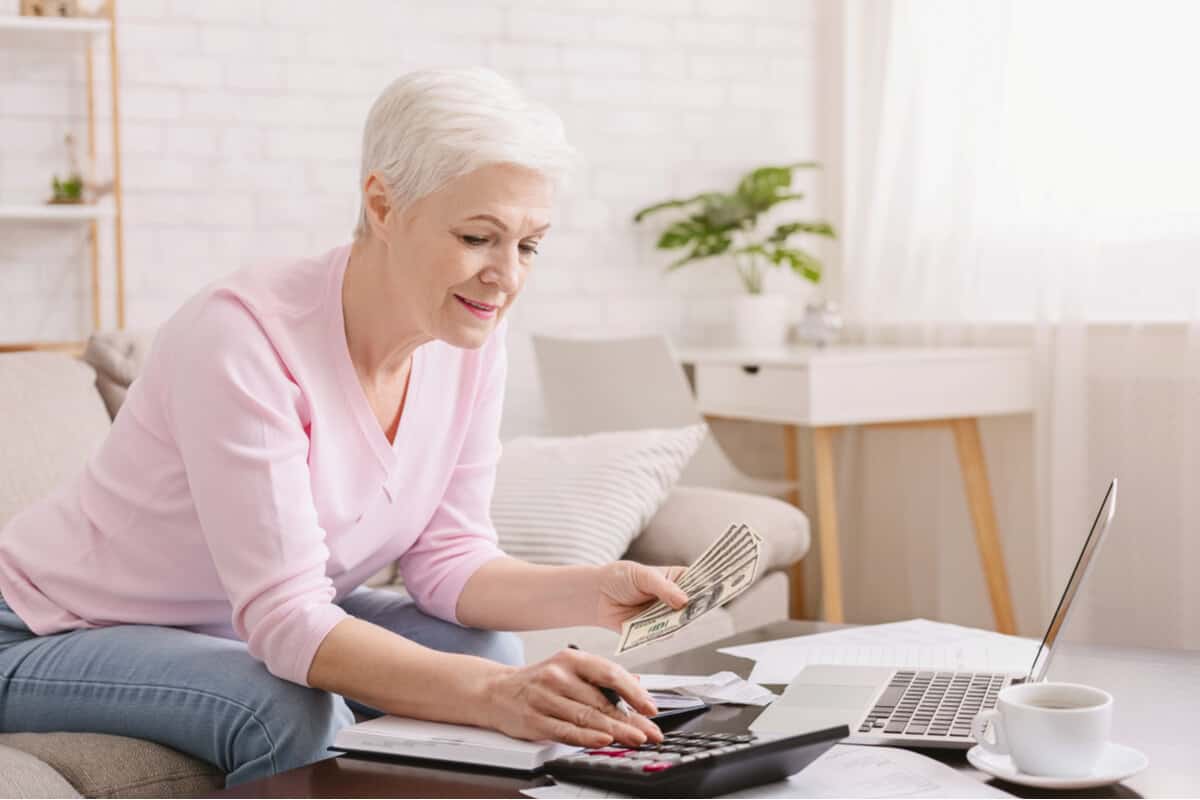 Woman typing on a calculator 