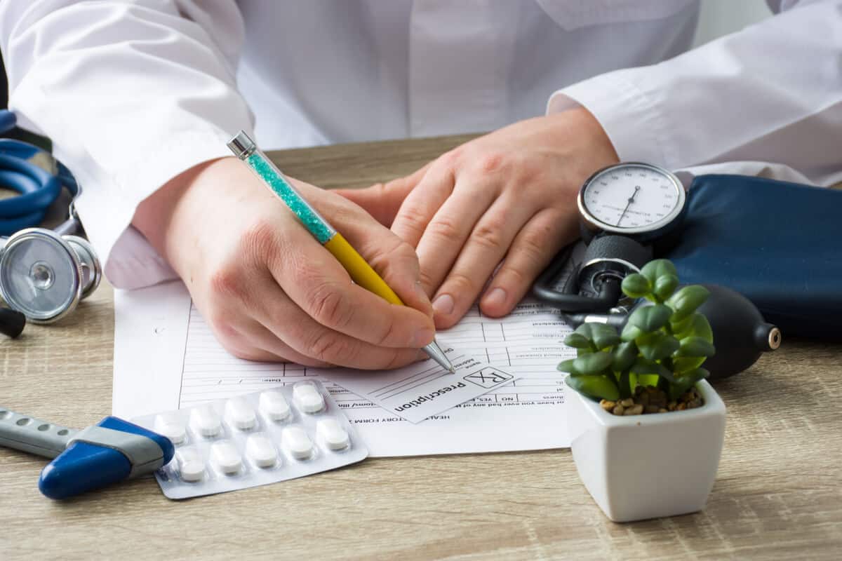 Practitioner writing a prescription