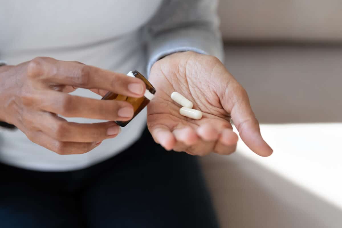 Woman holding a bottle of supplements