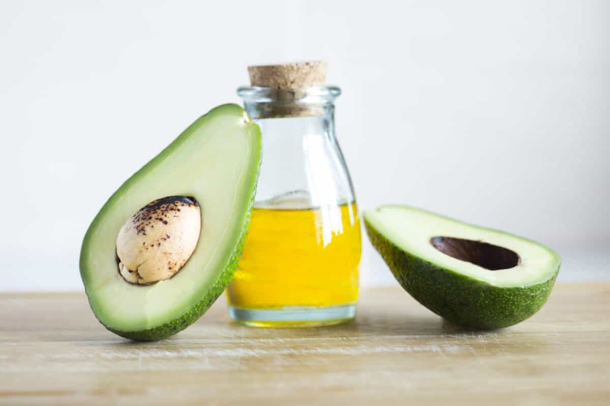 Avocados and a jar of olive oil