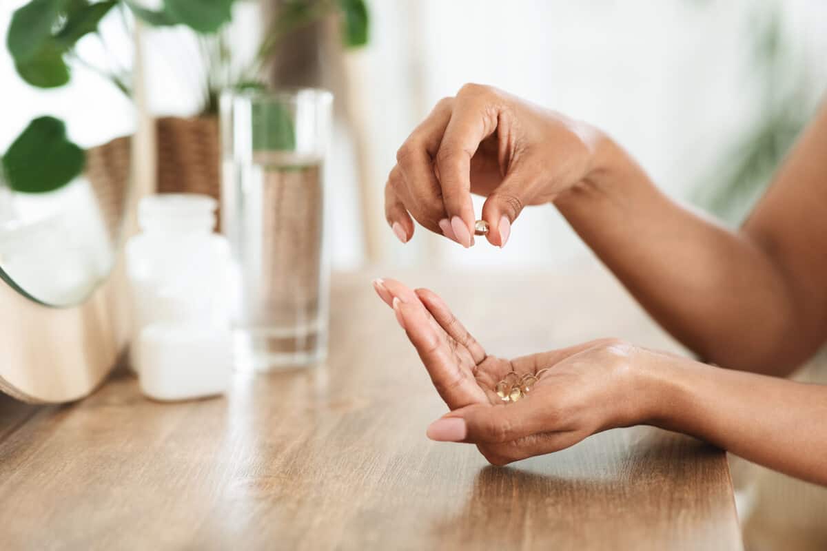 Woman taking a probiotic supplement
