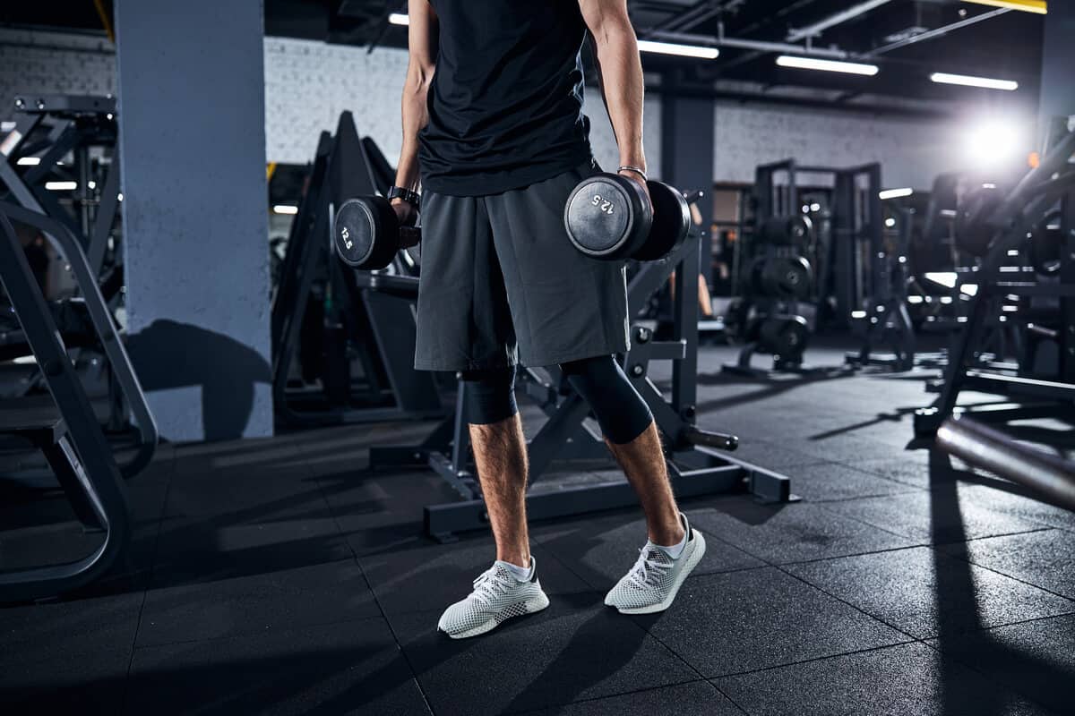Man lifting dumbbells at a gym