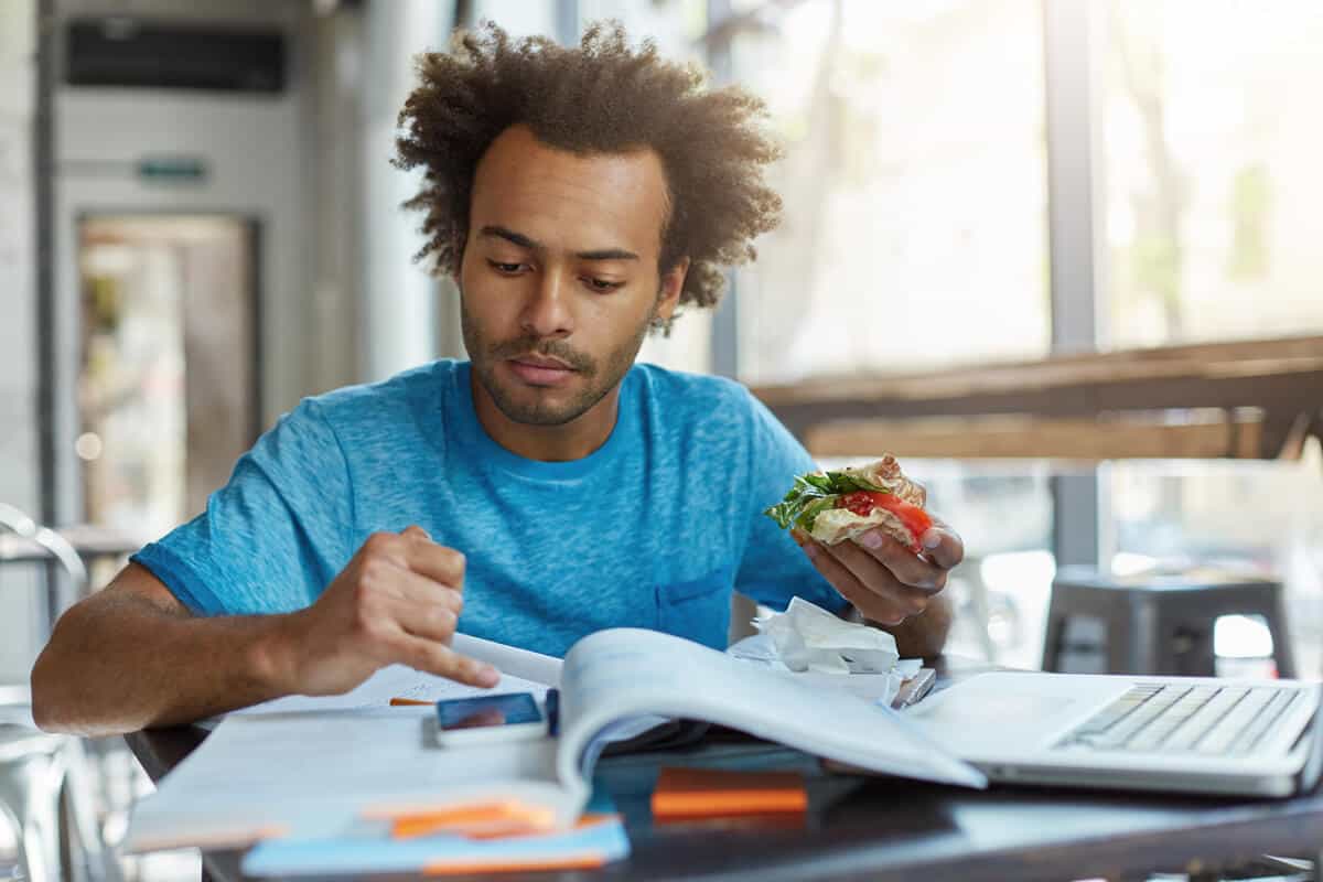 Man texting while eating
