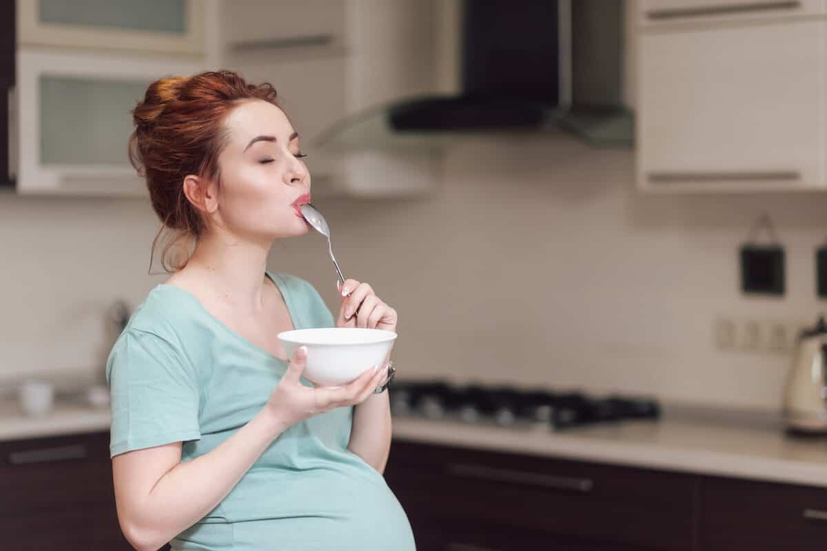 Woman licking a spoon