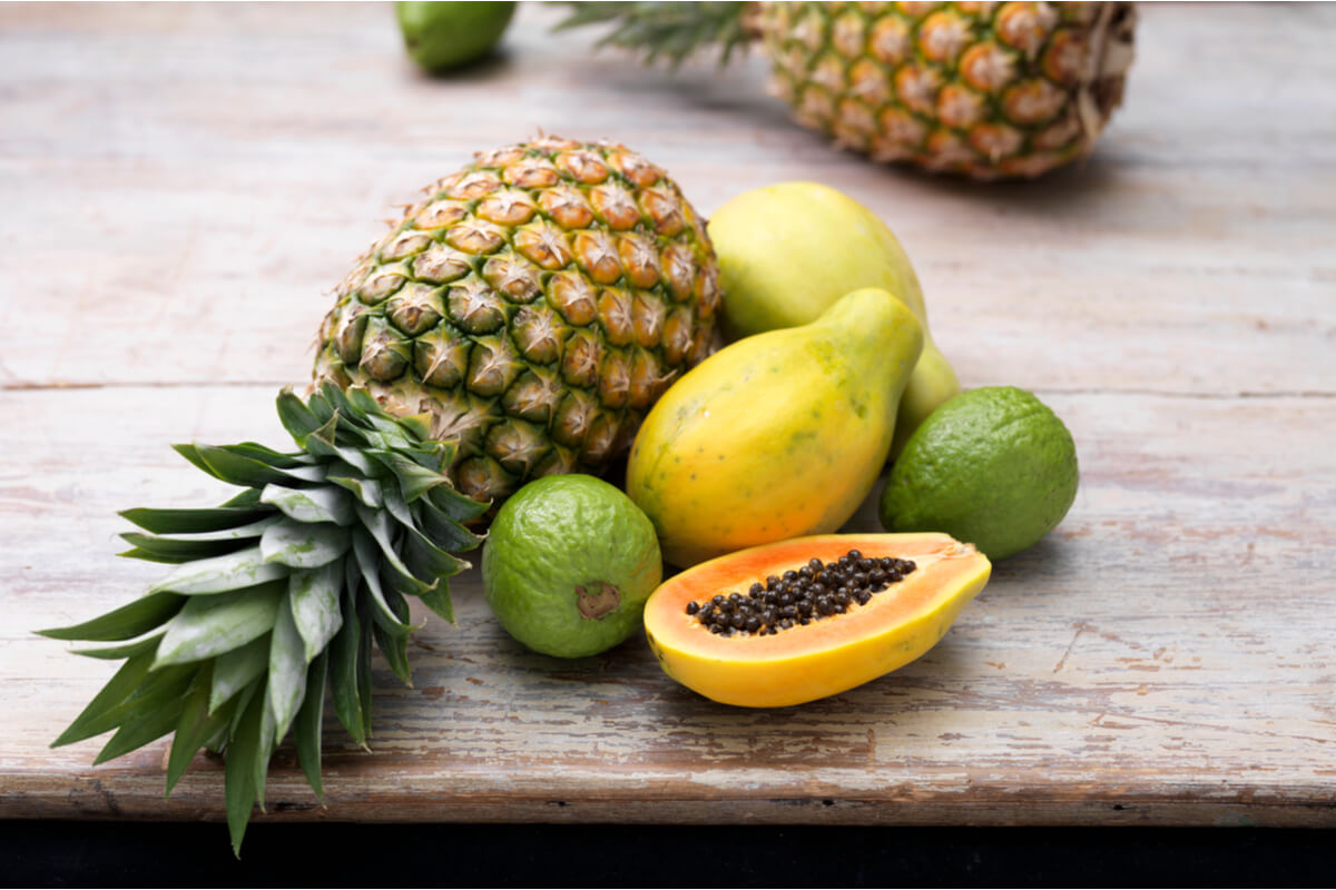 tropical fruits including kiwi, papaya, and pineapple