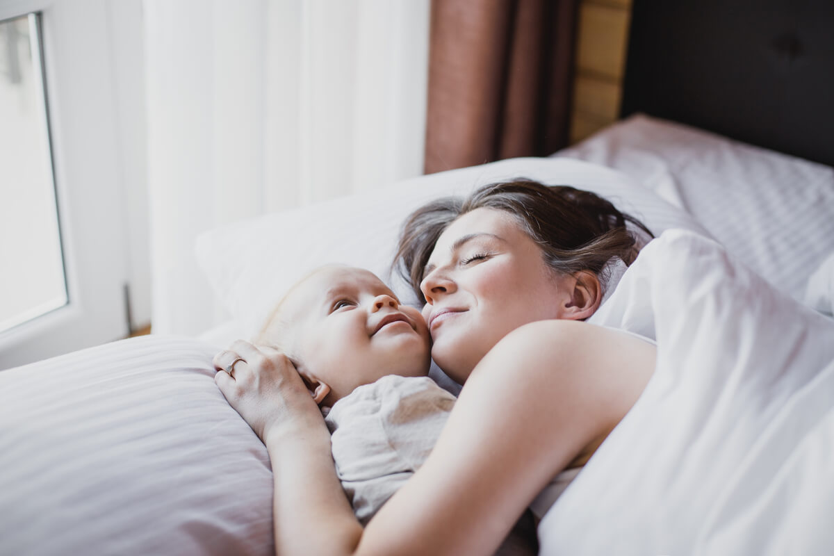 postpartum recovery tips woman holding baby