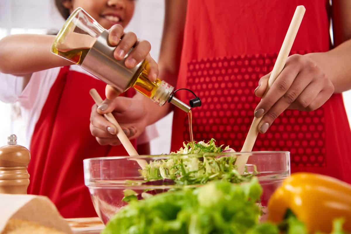 foods for kidney health adding olive oil to a salad