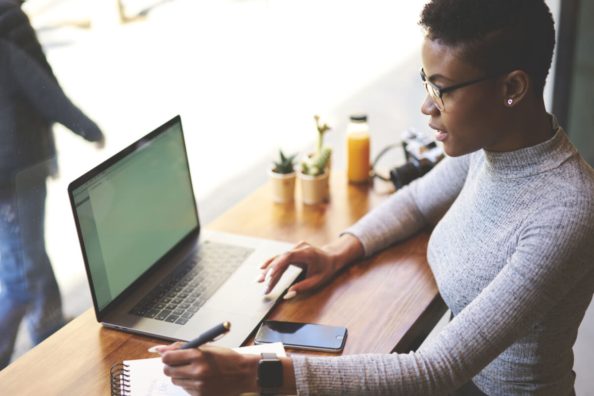 how to find an integrative medicine doctor woman researching on a laptop