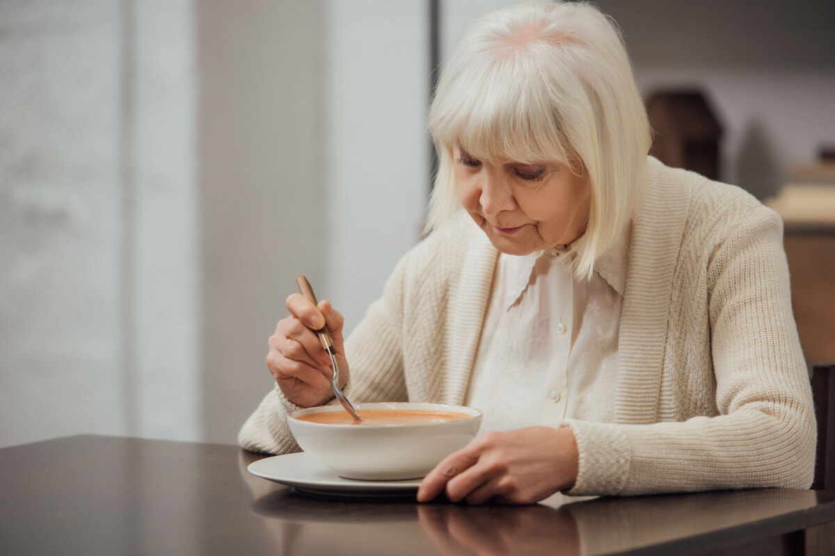 woman eating a bowl of bone broth soup