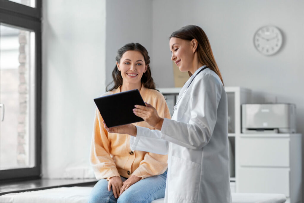 practitioner and patient looking at a tablet