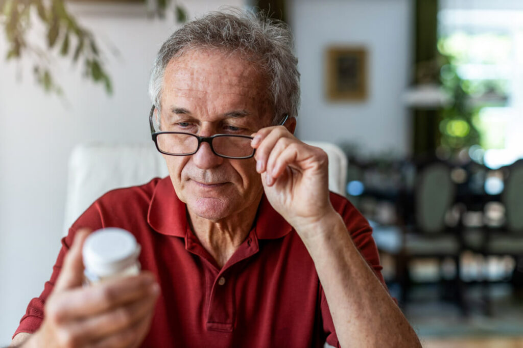 man reading supplement bottle label