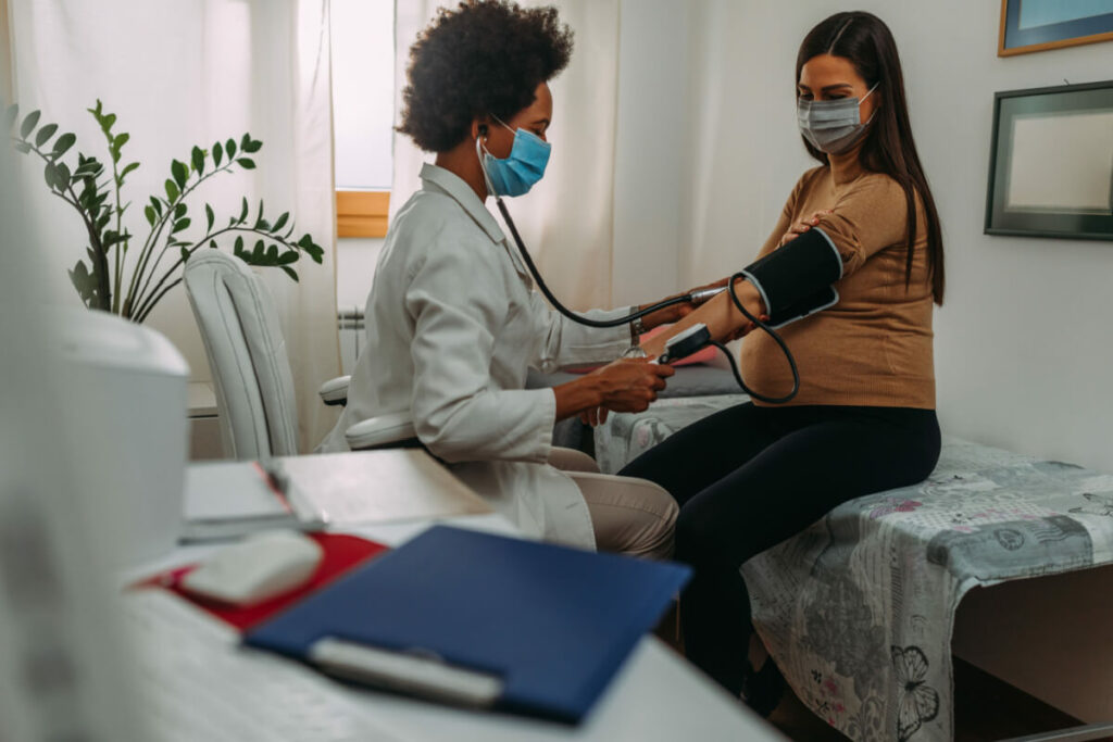 practitioner taking a patients blood pressure