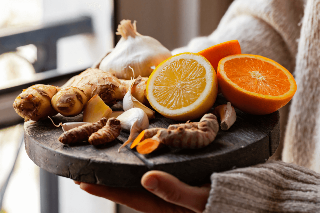tray of anti-inflammatory foods, including oranges, turmeric, and garlic