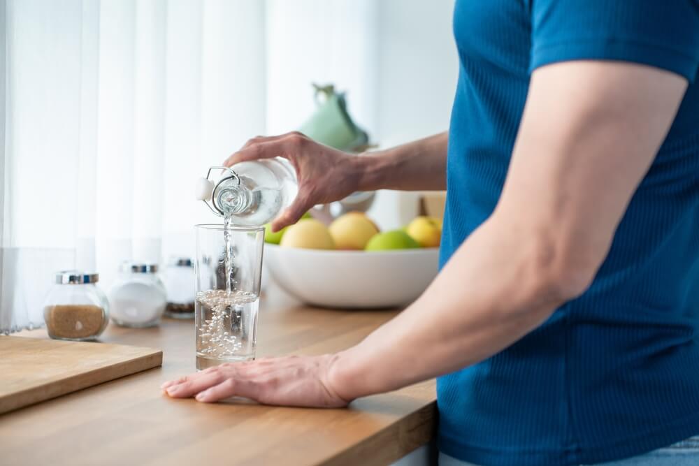 man drinking mineral water