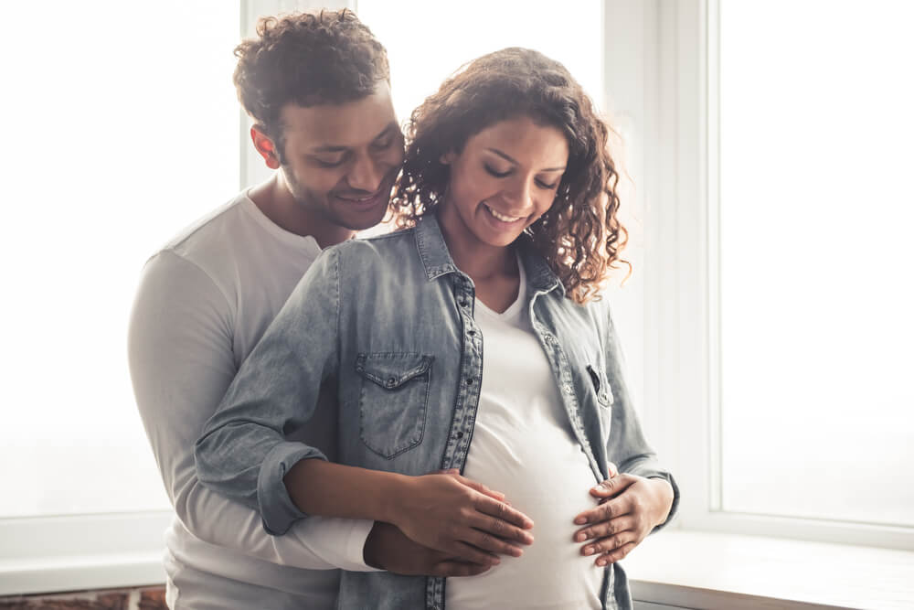 man holding a pregnant woman