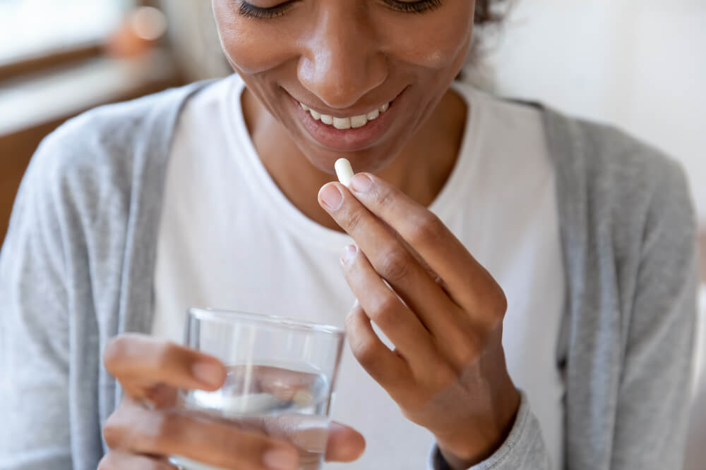 Woman taking a probiotic