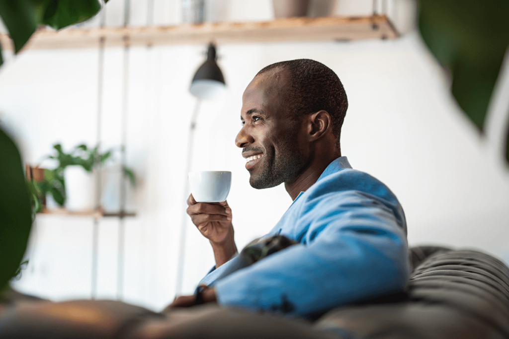man drinking a cup of green tea