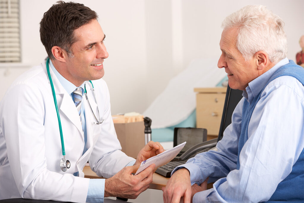 The image features a doctor and an elderly man engaged in a conversation.